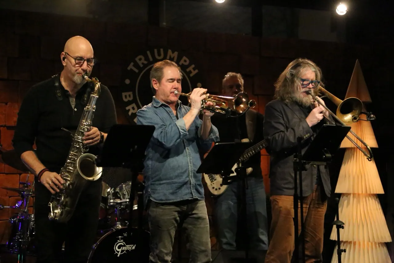 New York Horns on stage: saxophone, trumpet and trombone.