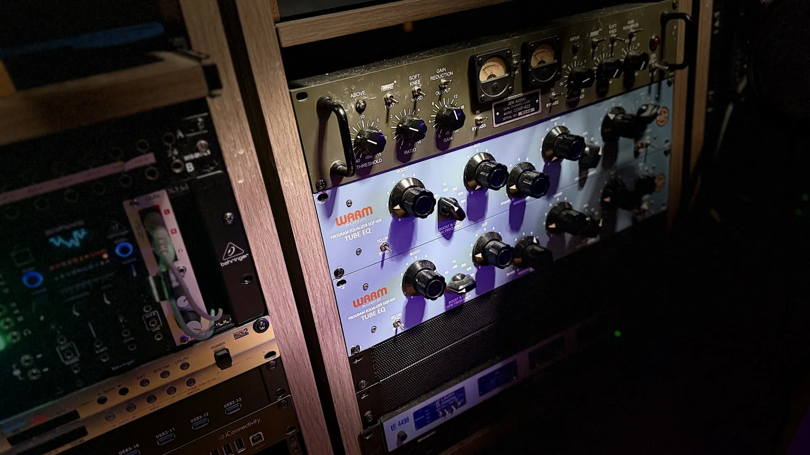 Racks of vintage-style compressors and outboard gear in the studio.