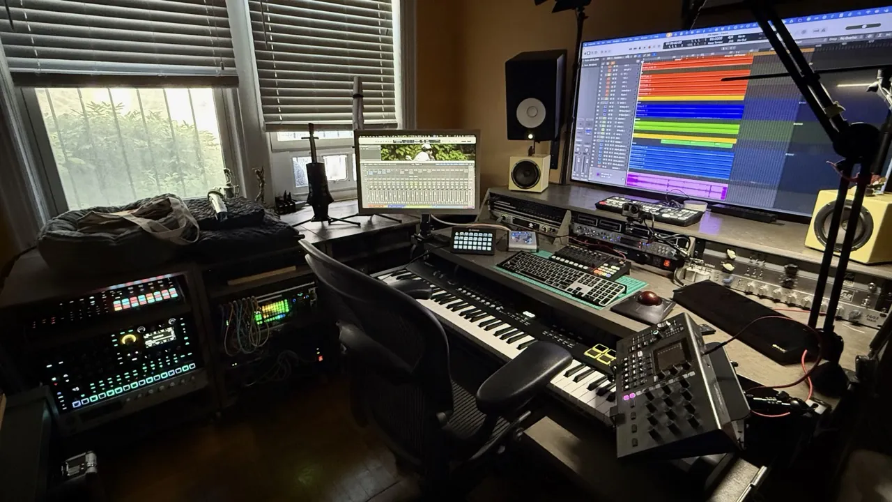 Studio Two, with a window, a second desk, keyboards and monitors.